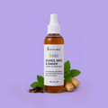 Skynfluent Kids Cloves, Mint & Ginger Leave-In Hair Mist bottle placed against a purple background with ginger, cloves, and mint leaves beside it.