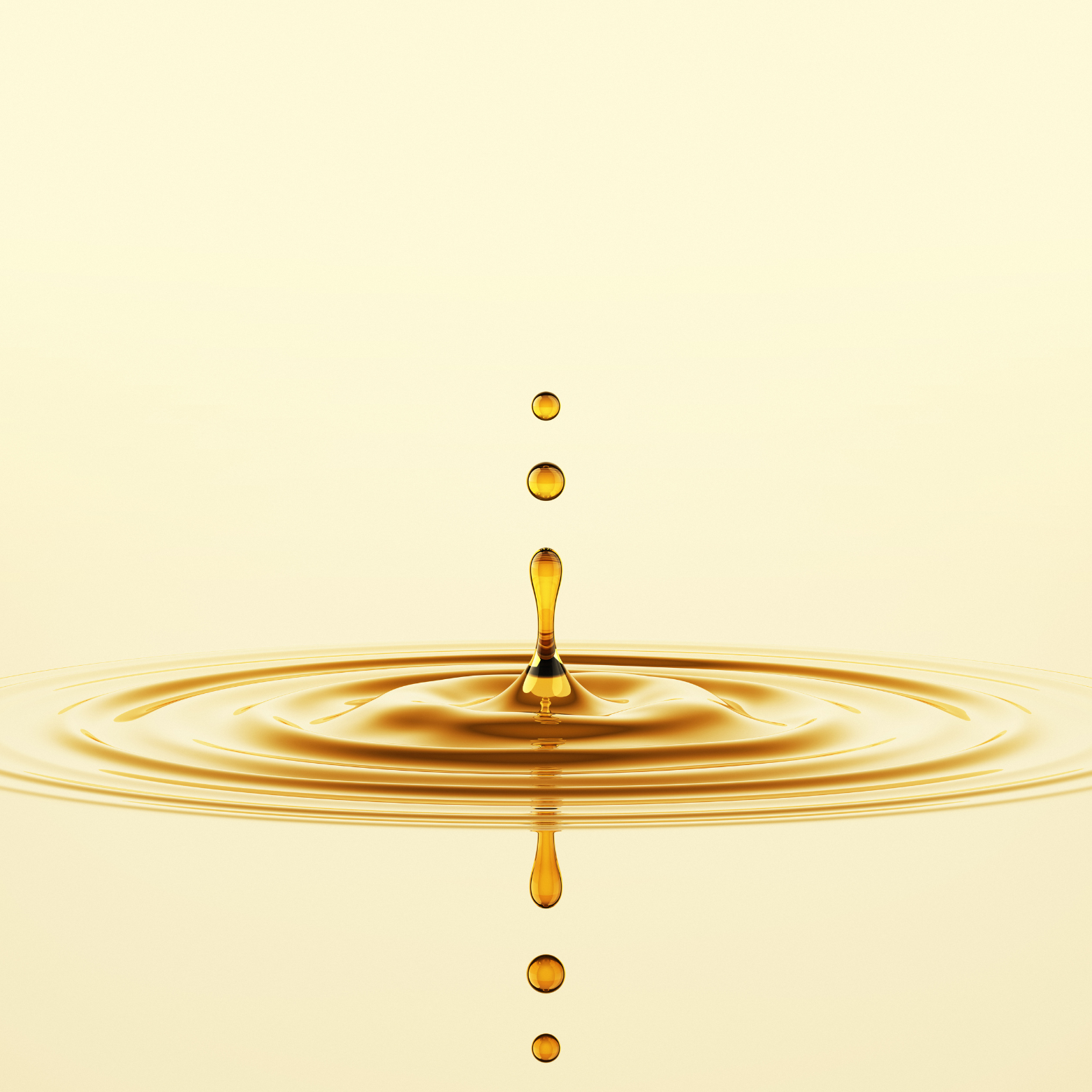 Golden oil droplets splashing in water – Skynfluent Liquid Gold Hair Oil rich in Ayurvedic botanicals and nourishing oils.